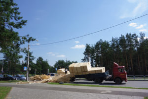 Semitruck with a spilled pallet of wood on the road